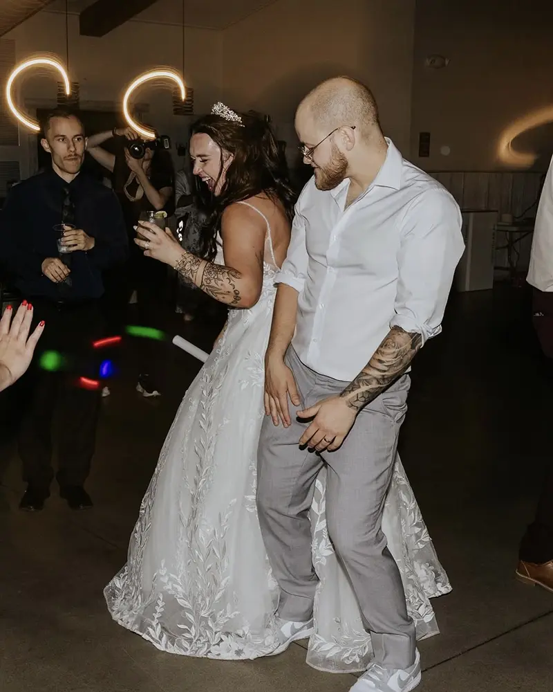 bride and groom dancing with wedding guests surrounding them
